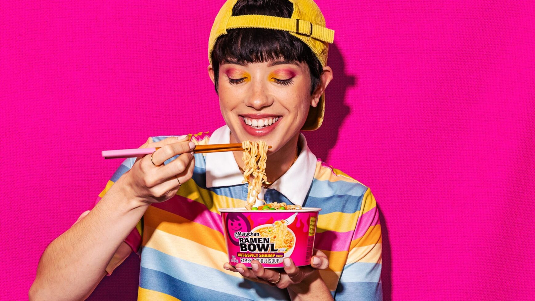 Person smiling while eating a ginormous bowl of Maruchan ramen